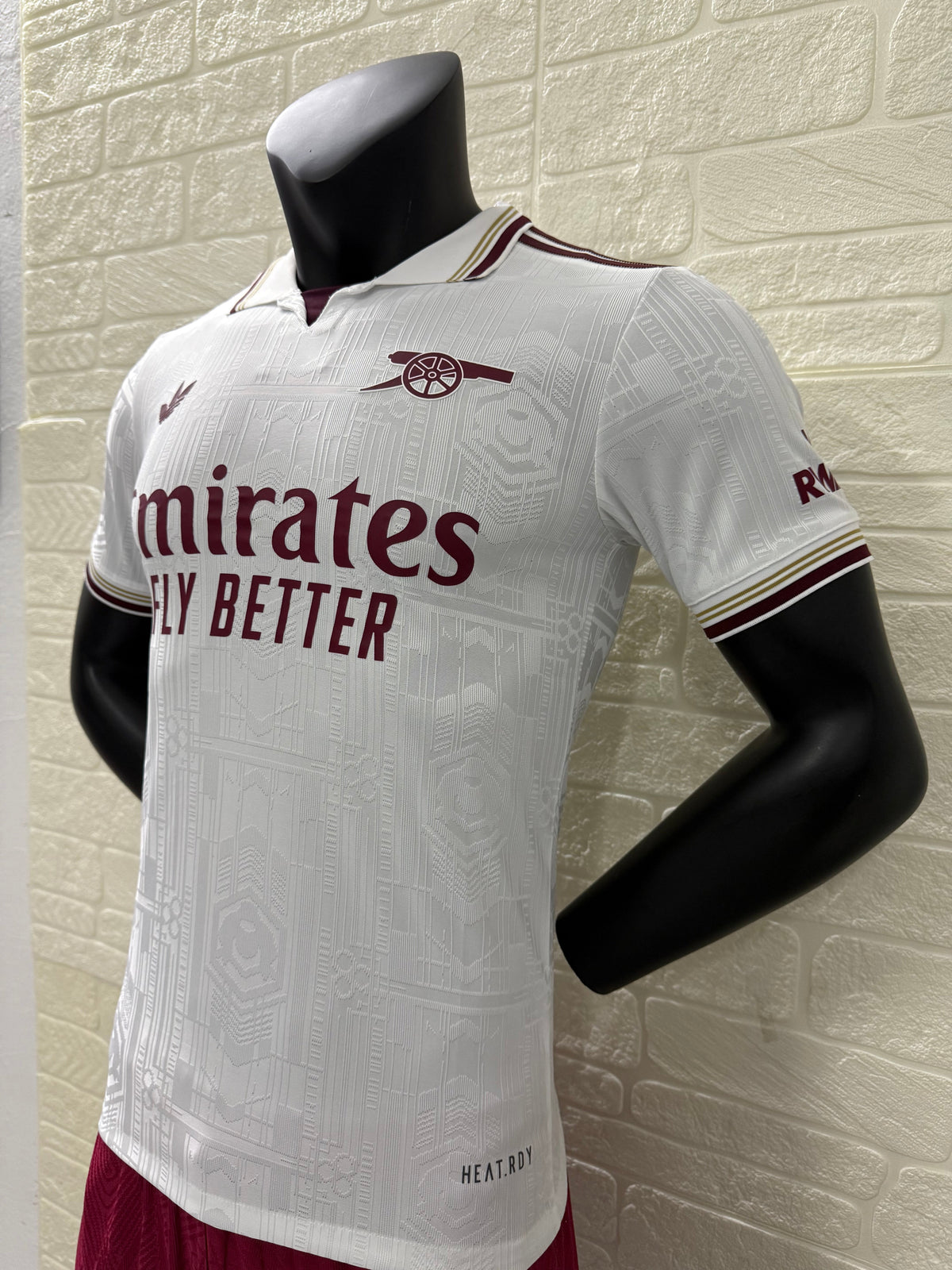 2025/26 Arsenal Third Player Version Jersey - White Body All-Over Subtle Tonal Graphic Texture Deep Maroon Polo Collar Gold Cream Stripe Trim Deep Maroon Sleeve Cuff Trim - Originals Trefoil - Arsenal Cannon Crest - Emirates Fly Better