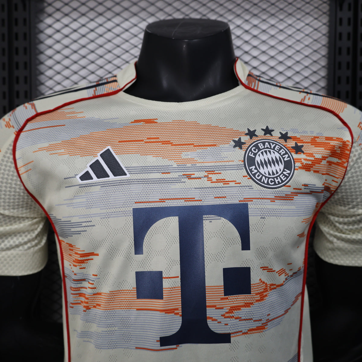2025/26 Bayern Munich Away Player Version Jersey -  Body Orange Grey Horizontal Brush Stroke Graphic  - Red Side Seam Piping Red Sleeve Cuffs Black Shoulder Stripes - FC Bayern Crest - Deutsche Telekom T Logo