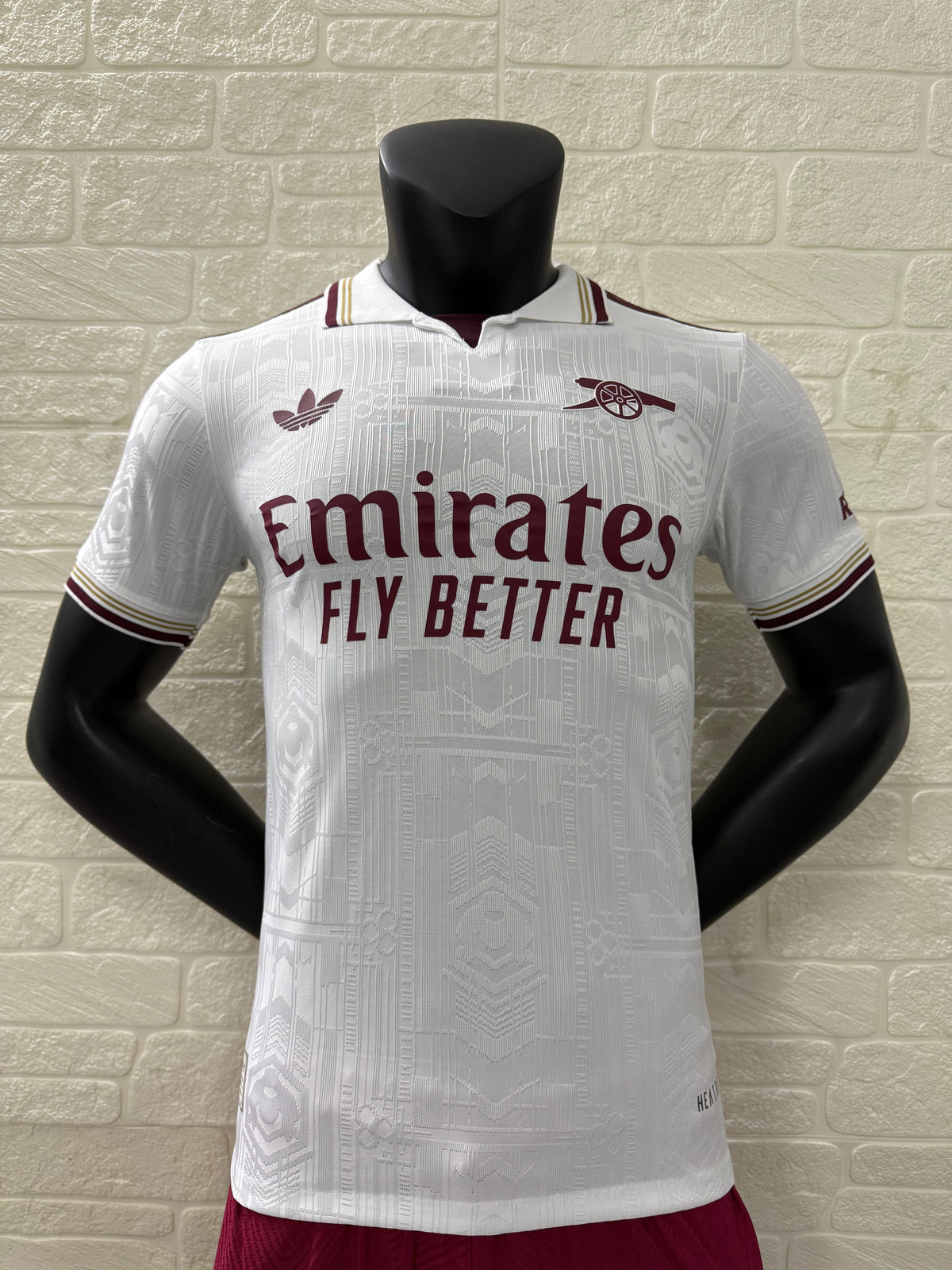 2025/26 Arsenal Third Player Version Jersey - White Body All-Over Subtle Tonal Graphic Texture Deep Maroon Polo Collar Gold Cream Stripe Trim Deep Maroon Sleeve Cuff Trim - Originals Trefoil - Arsenal Cannon Crest - Emirates Fly Better