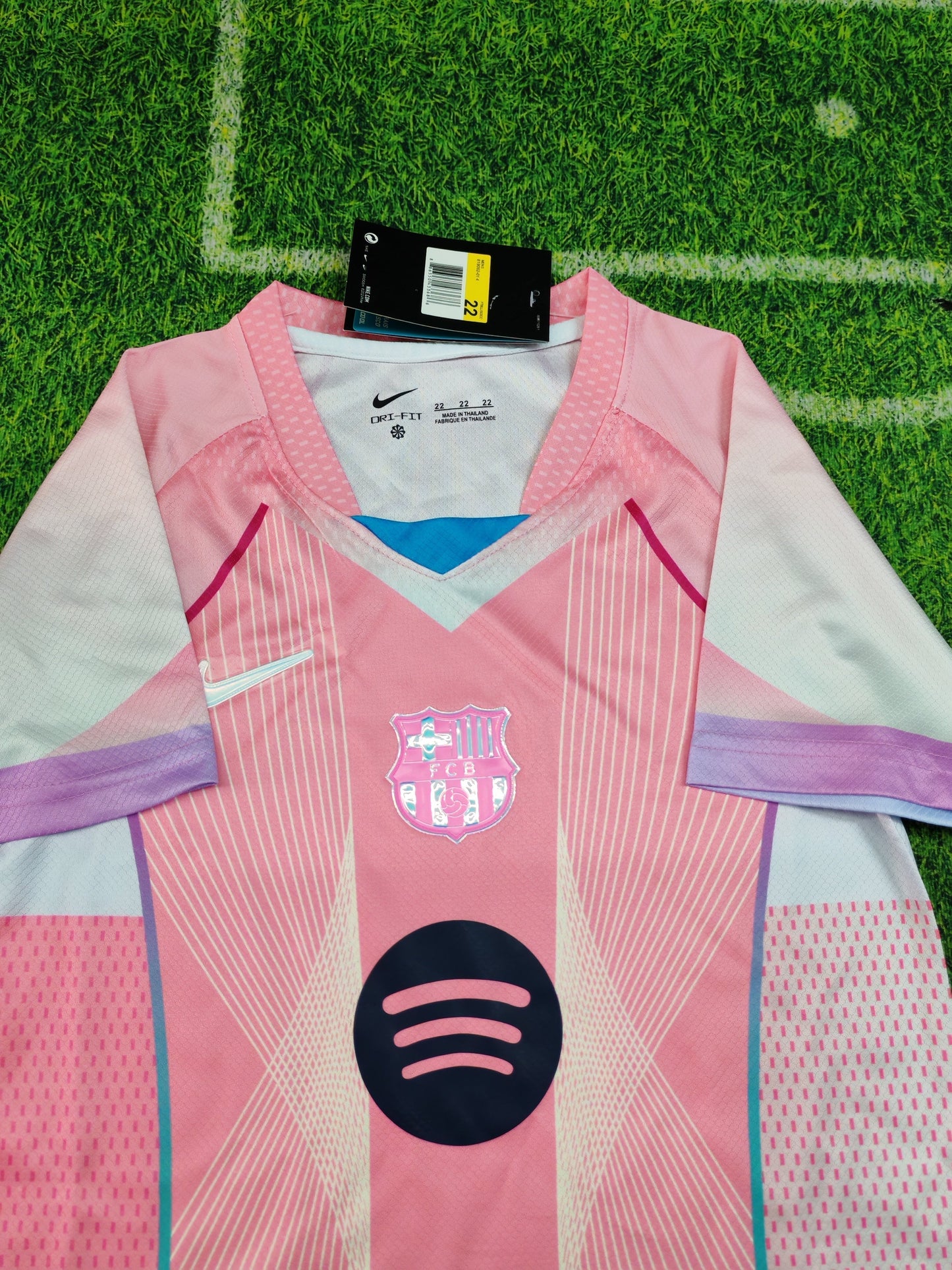 2025/26 FC Barcelona Kids Third Kit Set - Pink Jersey Navy Blue Shorts  - Pink Body White Lavender Sleeve Panels Teal V-Neck Geometric Radial Line Texture - White Nike Swoosh - FCB Pink Monochrome Crest - Spotify Navy Blue Sponsor